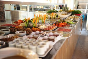 A buffet with various food items and utensils. - Usak Yucel Hotel (Usak)