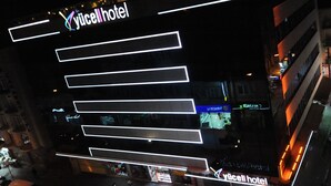 A hotel with a modern design, featuring illuminated signage and a prominent 'Yucell hotel' sign. - Usak Yucel Hotel (Usak)