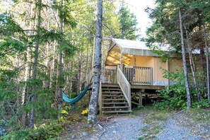 A cabin with a wooden deck and a hammock. - Dominion Hill Country Inn (Digdeguash)