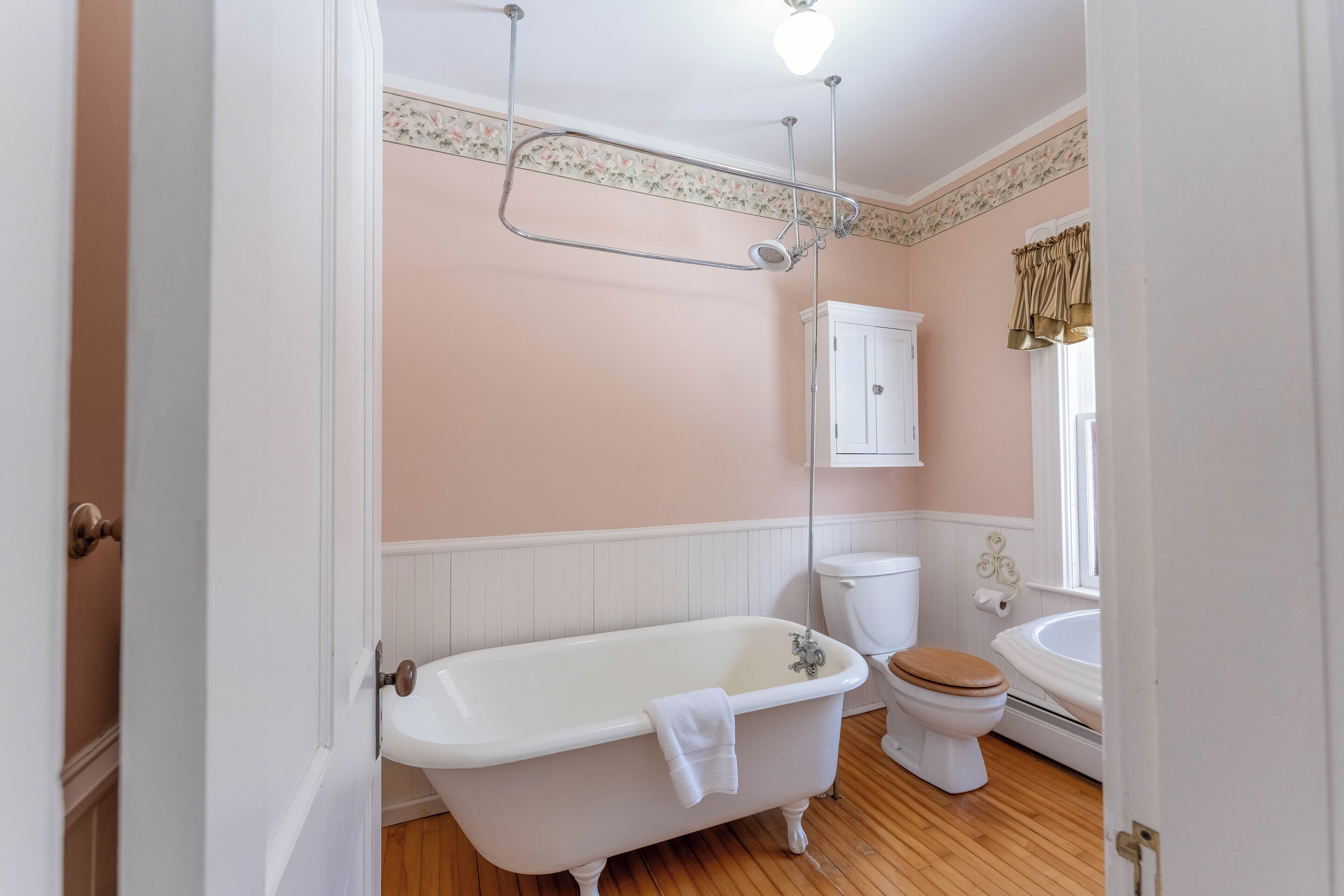 A bathroom with a freestanding bathtub, a toilet, and a sink.