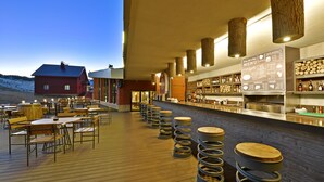 A waterfront restaurant with outdoor seating, a bar area, and a menu display. - Karinna Hotel Uludag (Bursa)