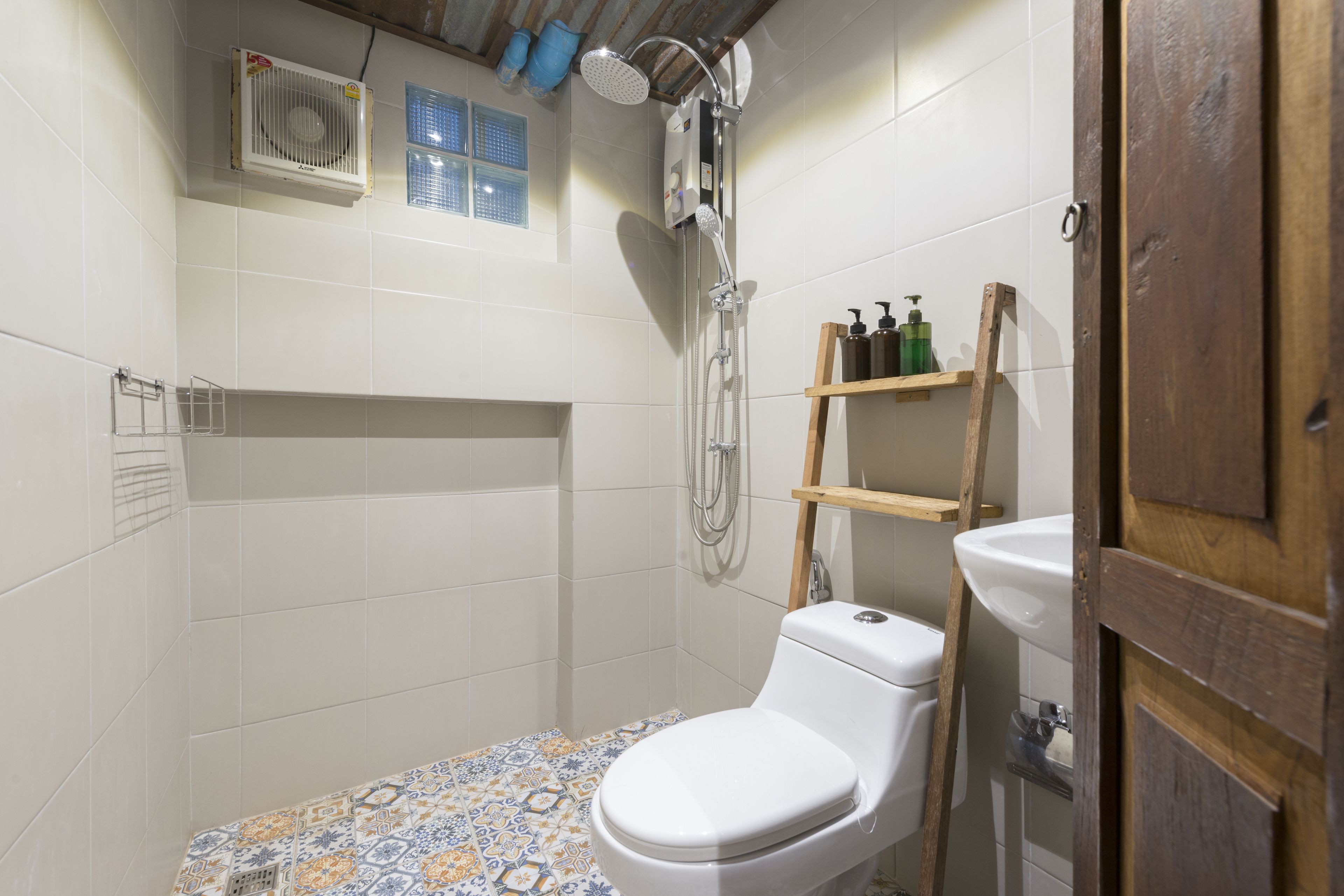 A bathroom with a shower, toilet, and sink.