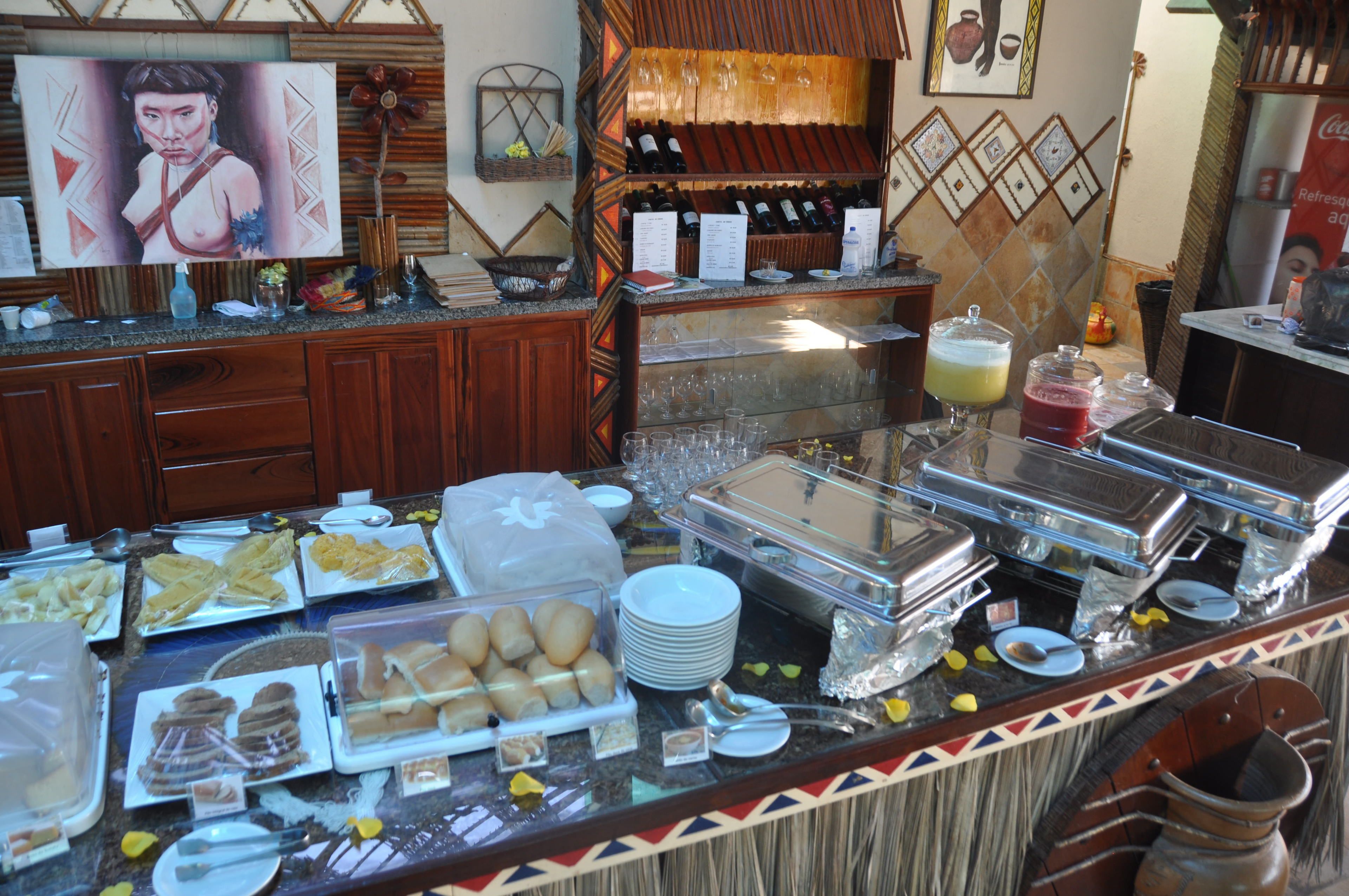 A buffet with various food items, a wine selection, and a beverage station.