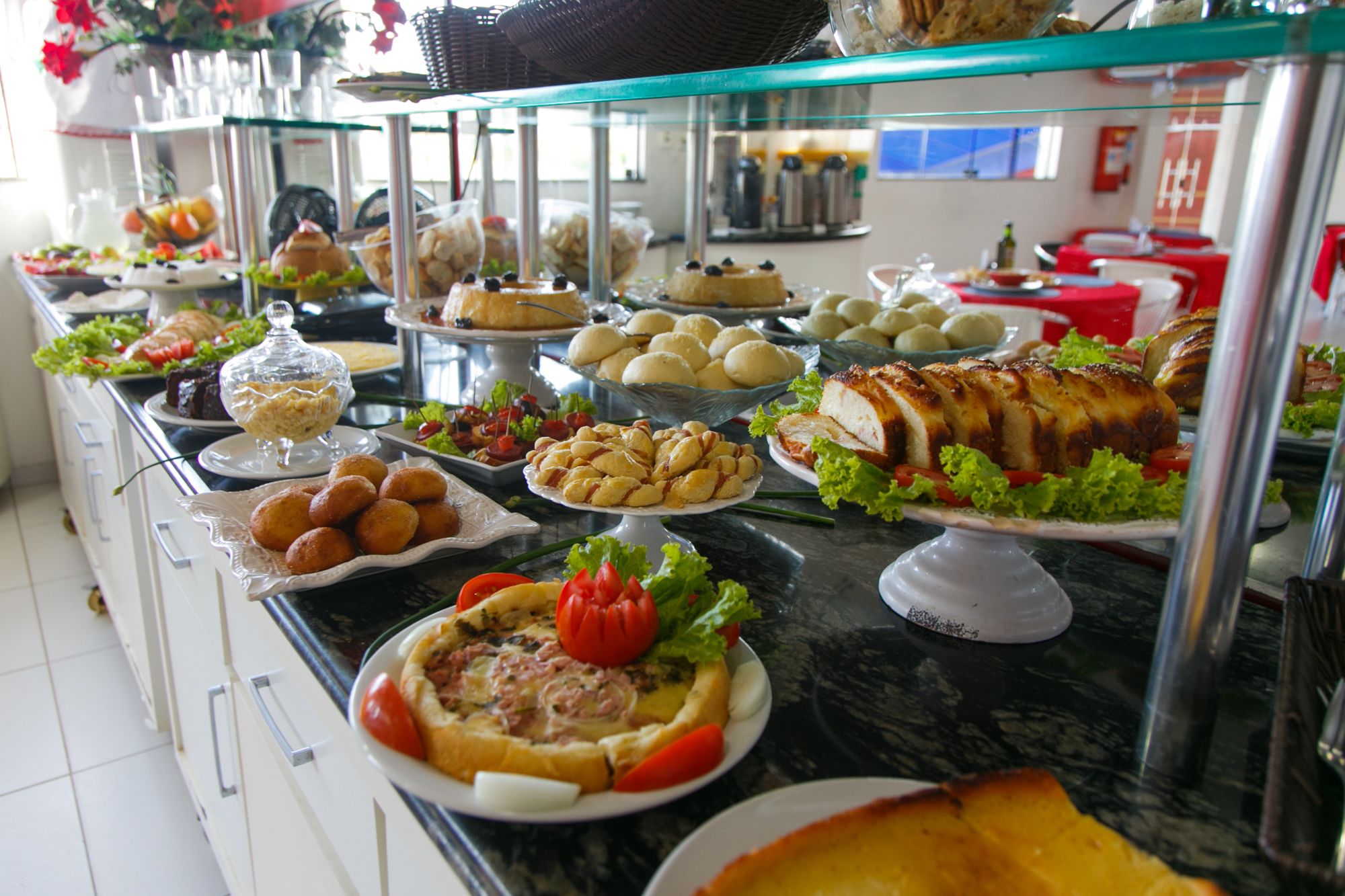 A buffet with various dishes including salads, bread, and a roasted chicken.