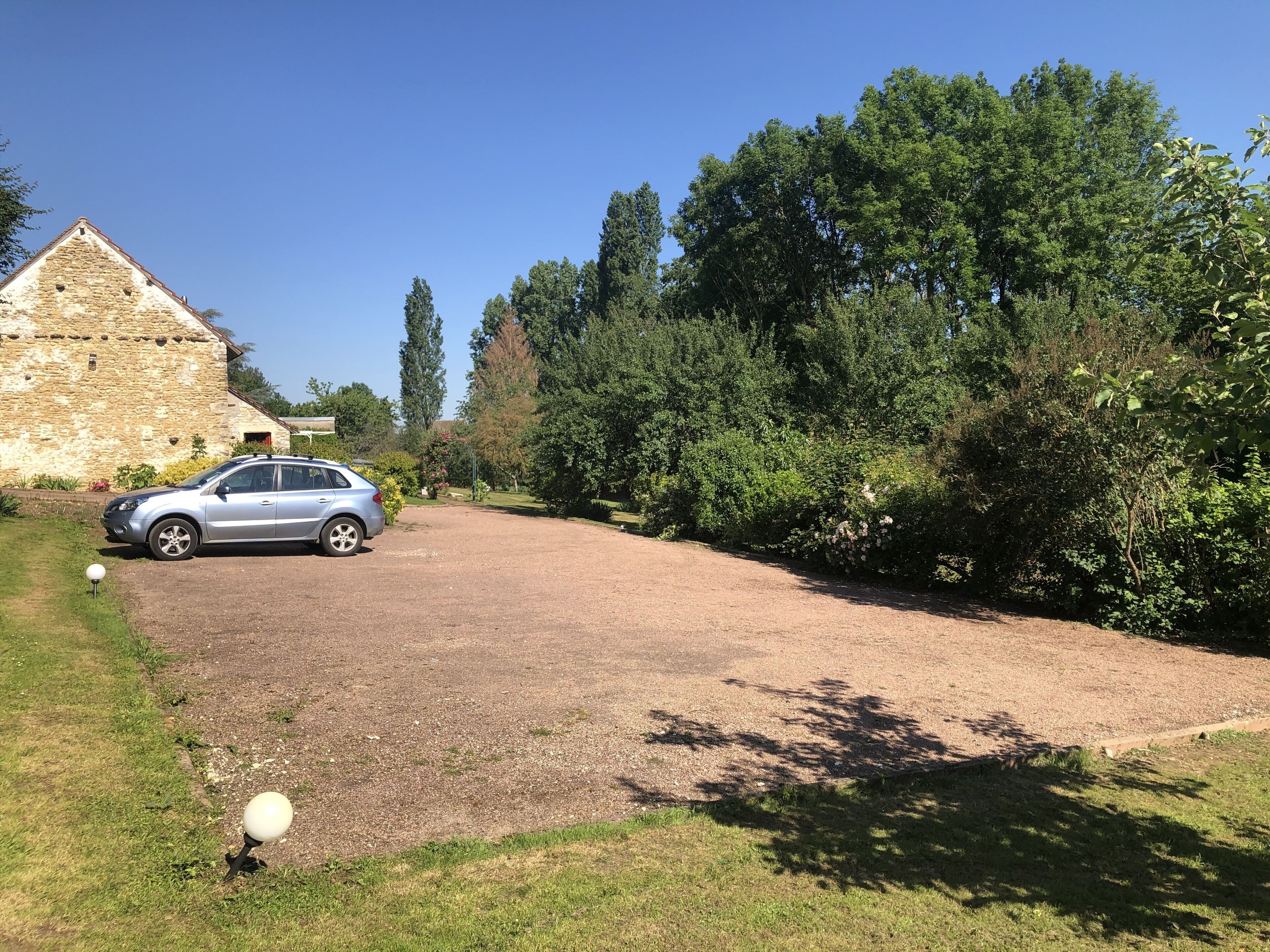 A stone building with a car parked in front.