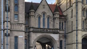 The University of Manchester's entrance with Gothic architecture, including pointed arches and a prominent tower. - Birchfields Guest House (Manchester)