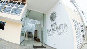 The exterior of Hotel Isla Bonita, featuring a modern design with a glass entrance and a prominent logo. - Hotel Isla Bonita (San Andrés)