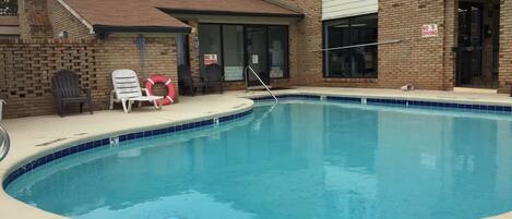 A swimming pool with a 'NO DIVING' sign and a depth marker of 5 feet.