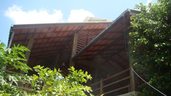 A building with a sloped roof and a visible staircase leading to an upper level.