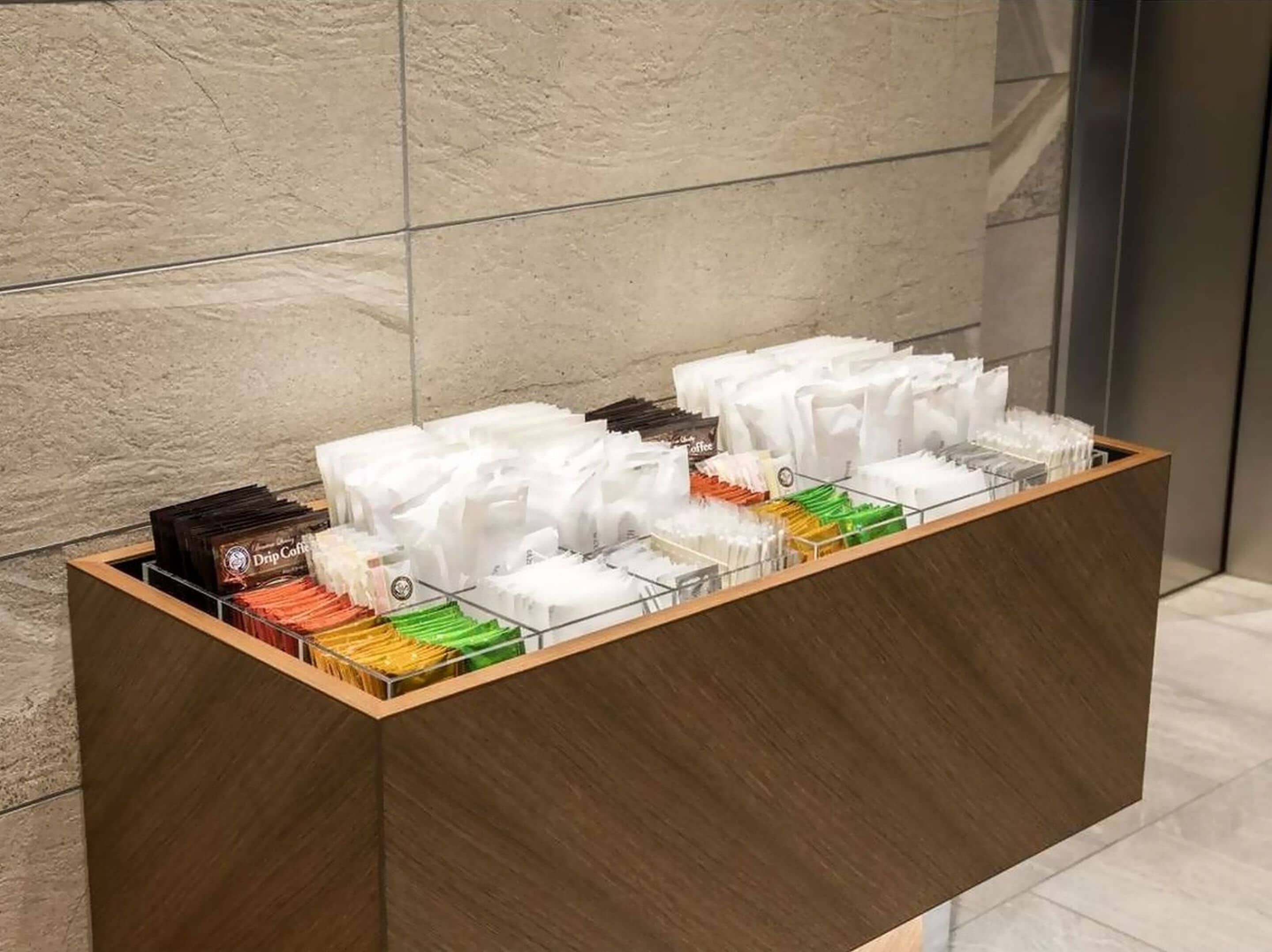 A coffee station with various drink dispensers and a coffee machine.