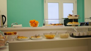 A breakfast buffet with various food items and a coffee station. - Domus Nova (Reggio Calabria)