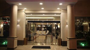 The entrance to Almuhaidb Residence with a clear glass door, a prominent logo, and a well-lit interior. - AlMuhaidb Residence Al Khafji (Al Khafji)