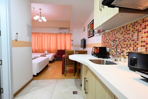 Deluxe Quadruple Room, 2 Double Beds, Kitchen, Courtyard View | Private kitchen | Fridge, microwave, electric kettle - Cedar Peak Condominium by Tripsters Hub (Baguio)