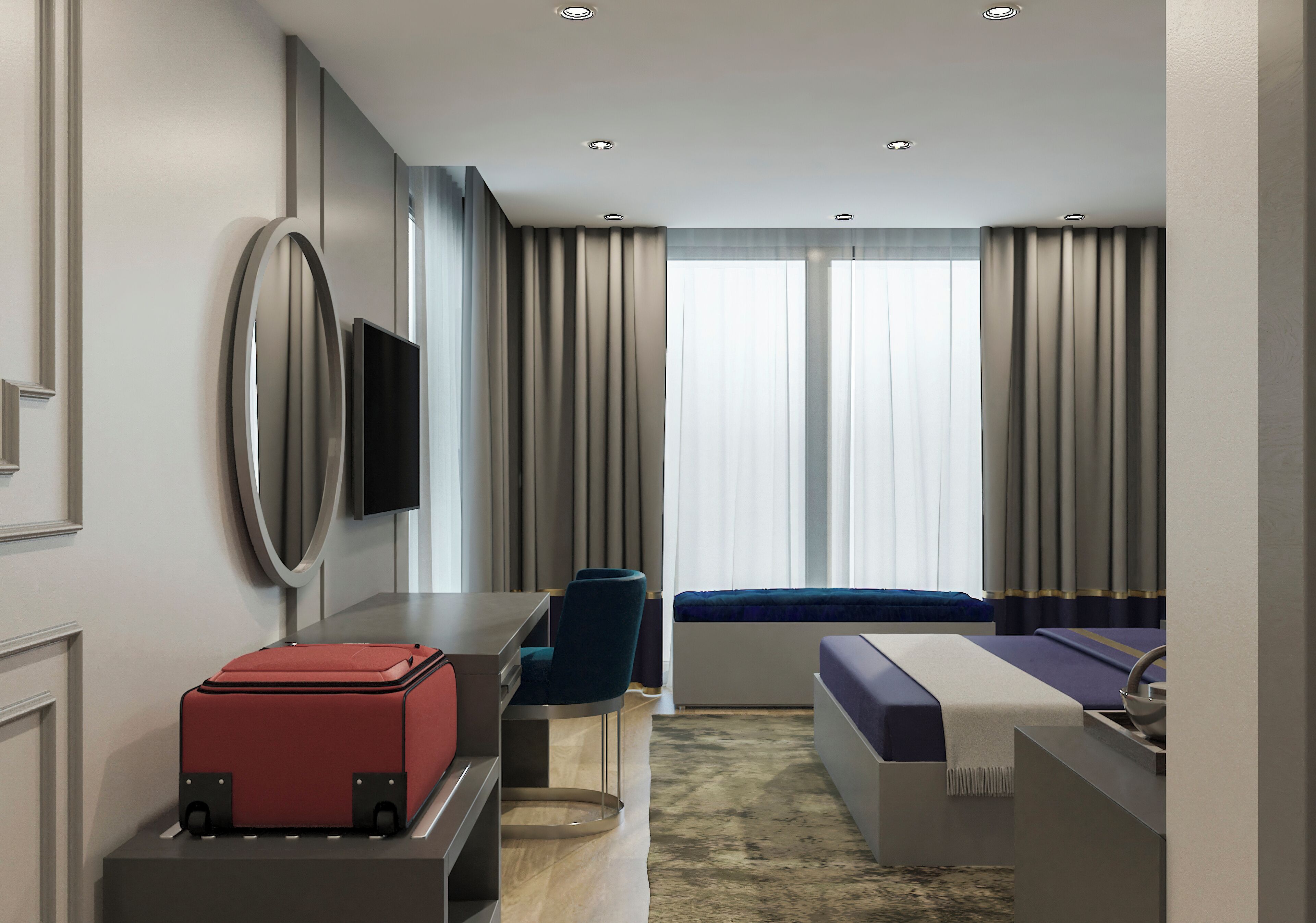 A modern hotel room with a desk, chair, bed, and a red suitcase.