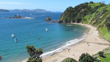 On the beach, white sand, sun-loungers, beach umbrellas
