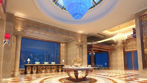 A grand lobby with a central round table, a large chandelier, and a high ceiling with a skylight. - Gin Mao Yuan Hotel Shenzhen (Shenzhen)