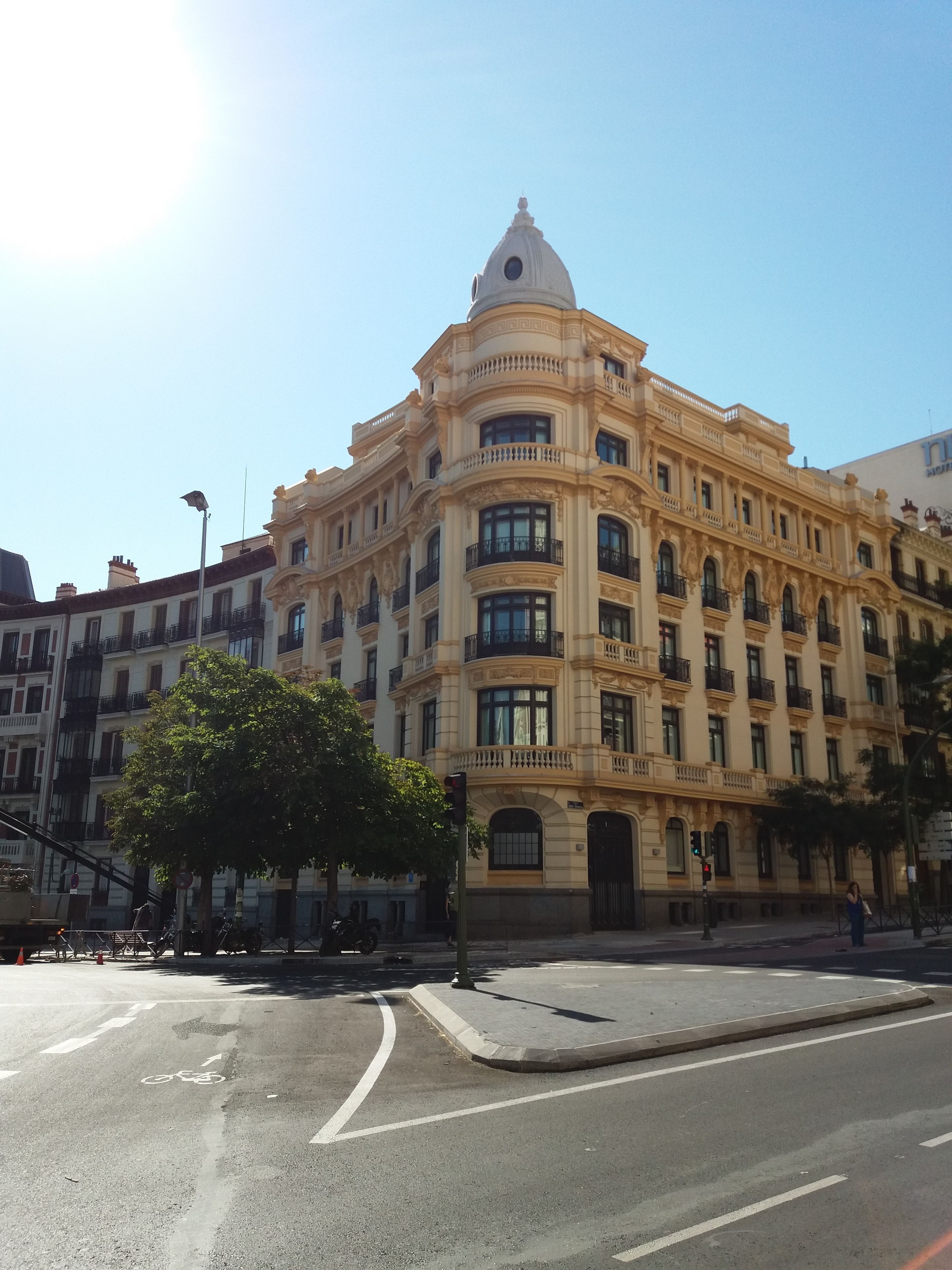 A historic building with ornate architecture, multiple balconies, and a prominent dome.