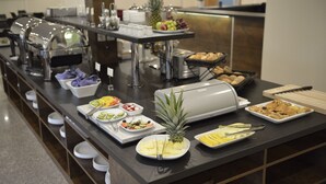 A buffet setup with various food items and utensils. - Hotell Nova (Karlstad)