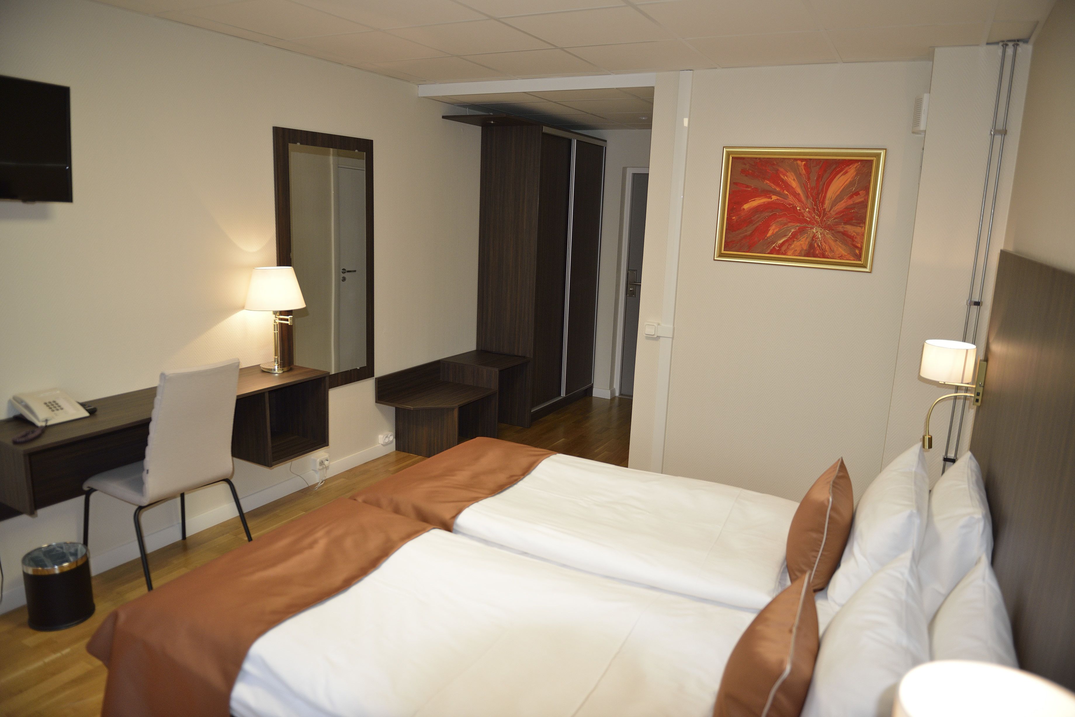 twin room | desk, laptop workspace, blackout curtains, iron/ironing board