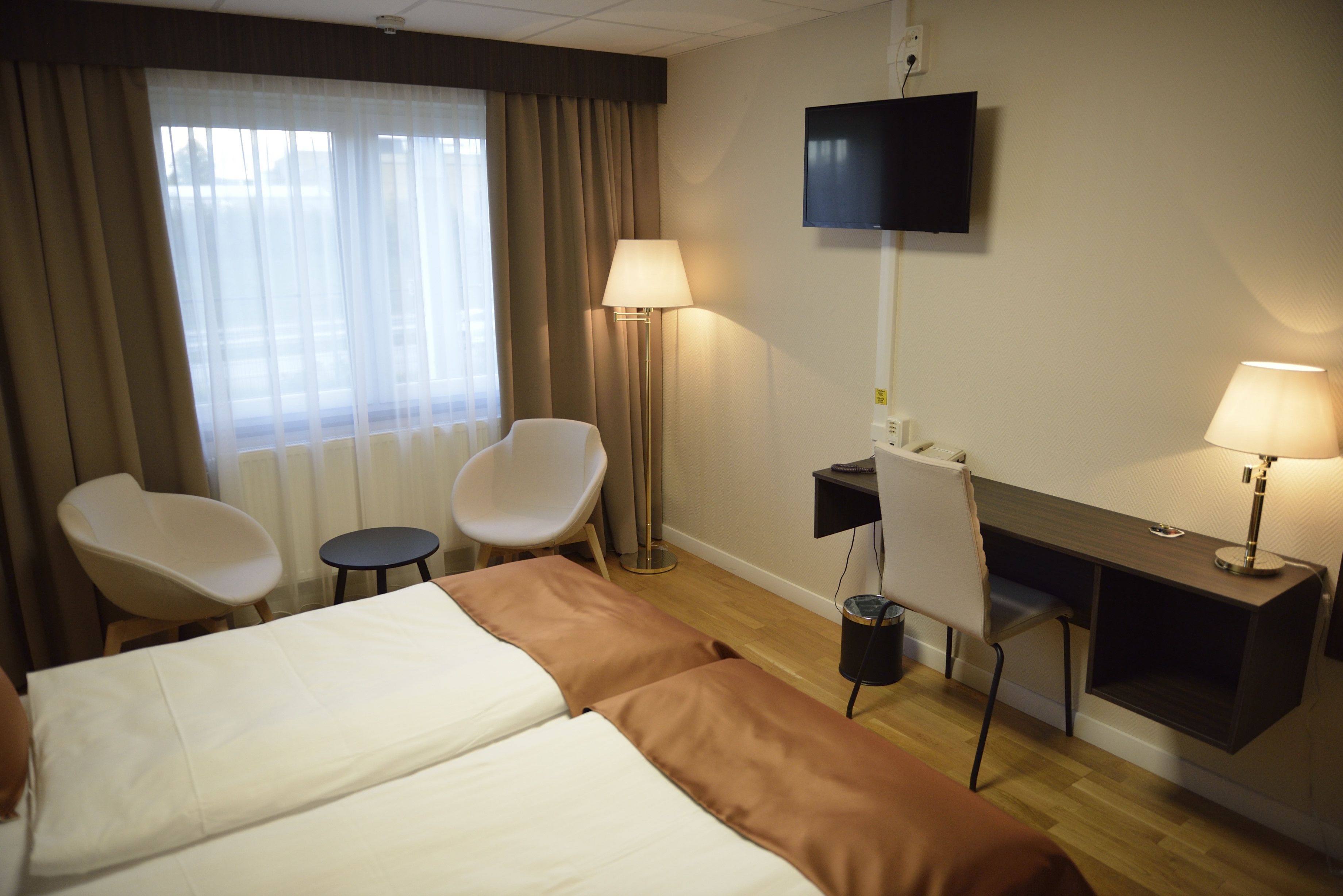 twin room | desk, laptop workspace, blackout curtains, iron/ironing board