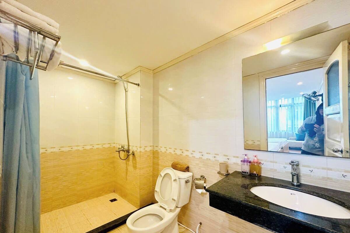 A bathroom with a shower, toilet, and sink.