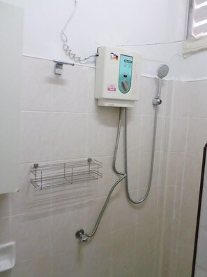A bathroom with a shower, a towel rack, and a wall-mounted heater. - Aonang SR Bungalow (Krabi)