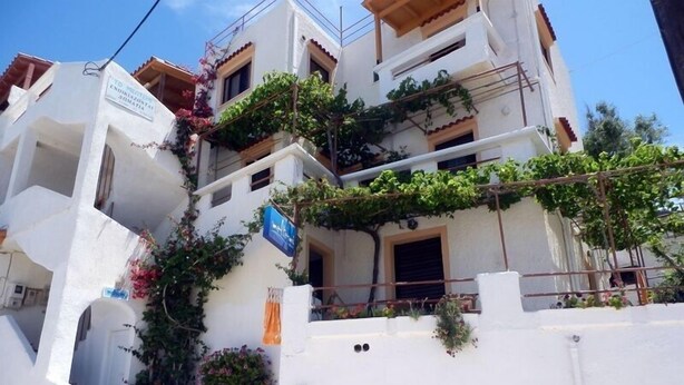 A multi-story building with white walls and balconies.