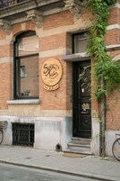 A brick building with a black door and a sign that reads "Simone Kitchen."