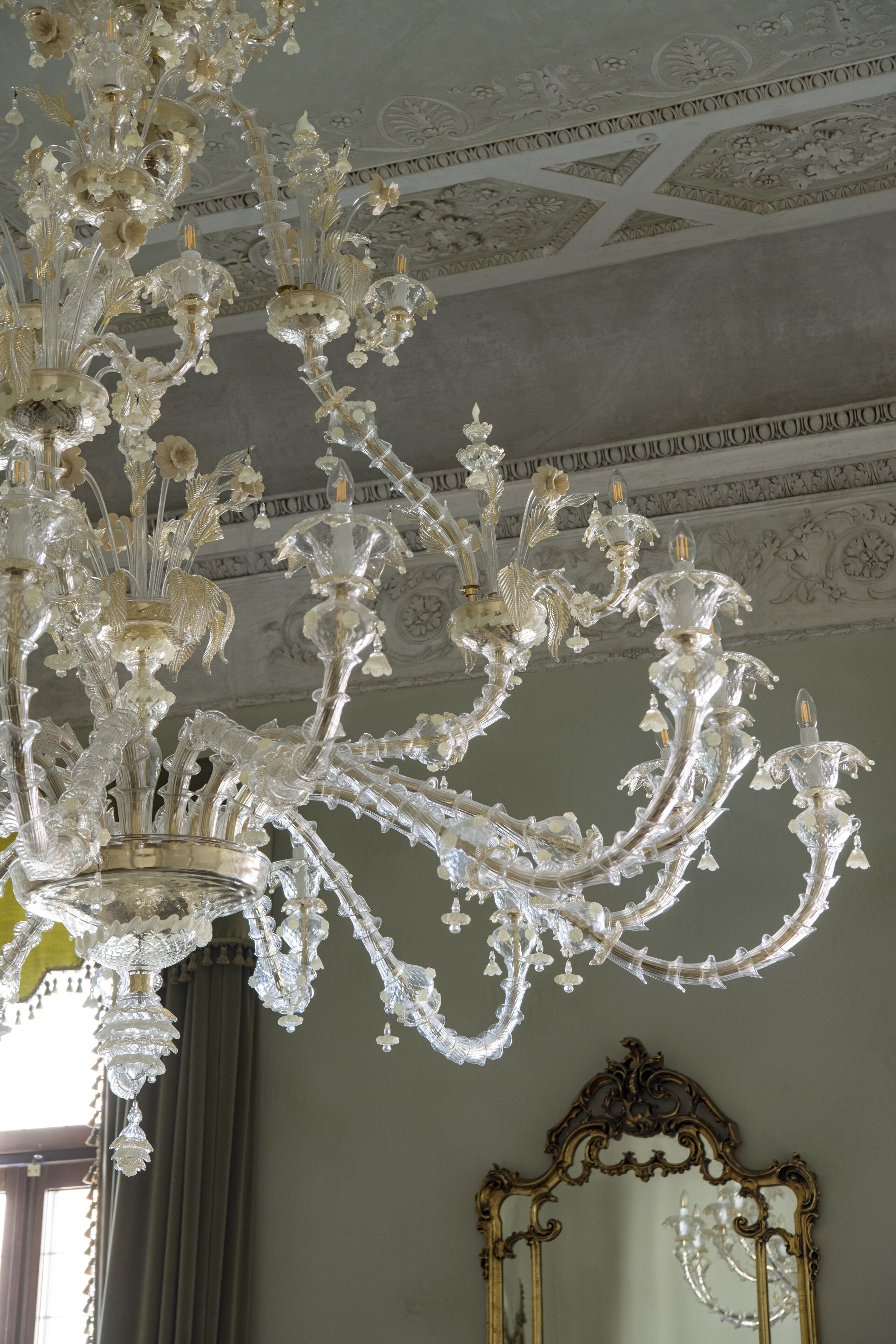 A grand chandelier with intricate designs and multiple light fixtures.