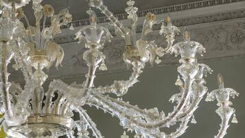A grand chandelier with intricate designs and multiple light fixtures.