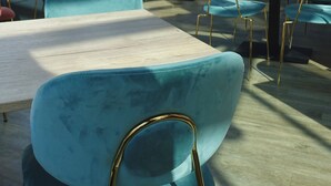 A restaurant with teal chairs, tables, and a modern design. - Hôtel de la Gare (La Roche-sur-Yon)