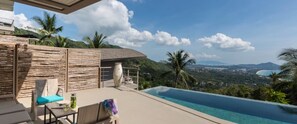 A poolside area with a view of a coastal landscape, including mountains and a beach. - Villa Lipe at Comoon Boutique Villas (Koh Samui)