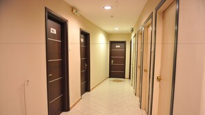 A corridor with doors numbered 405 and 407, leading to rooms. - Hotel Emporiko (Drama)