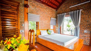A room with a wooden bed, brick walls, and a window with curtains. - Ninh Binh Mountain View Homestay (Tay Hoa Lu)