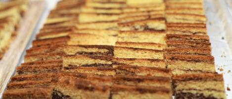 A tray of neatly arranged rectangular cake pieces.