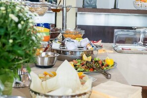 A buffet setup with various food items and utensils. - Hotel On Plonge Junior (Constanta)
