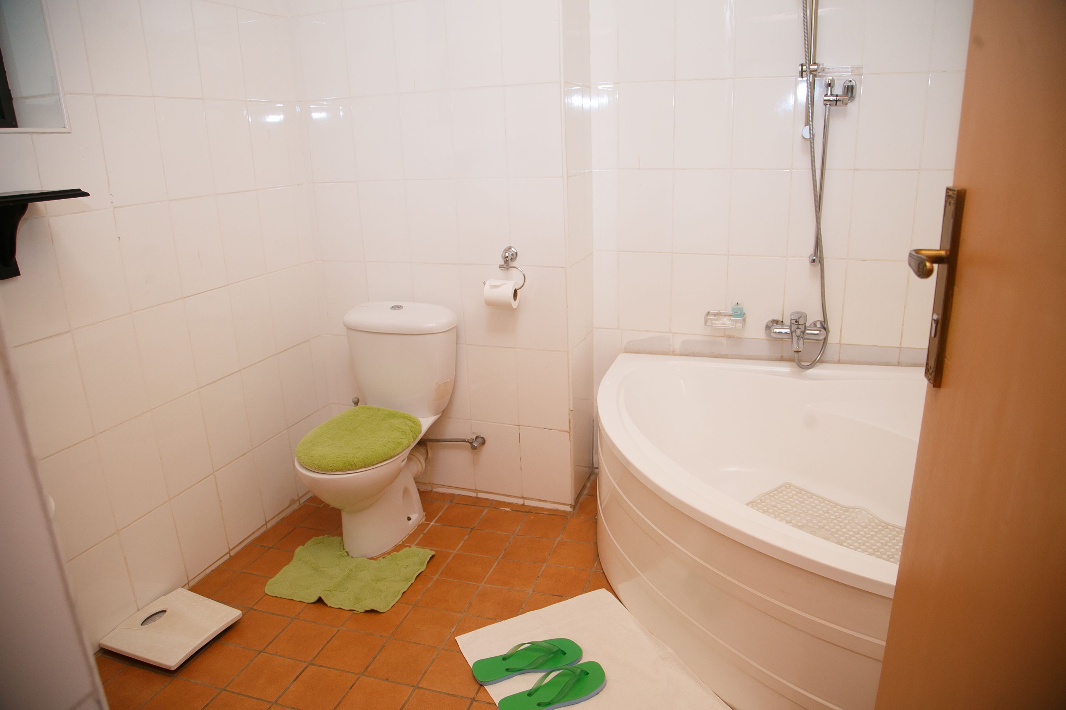 A bathroom with a toilet, a bathtub, and a shower.