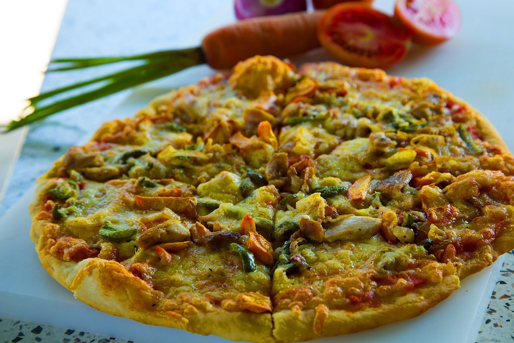 A pizza with various toppings on a white plate.
