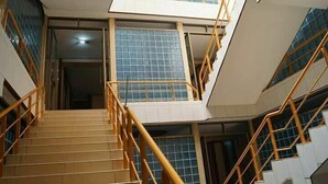 A staircase with a metal railing leading to an upper floor. - JBK Hotel (Kampala)