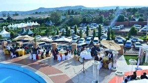 A parking lot with several tents and tables set up, likely for an event or gathering. - Nican Resort Hotel (Kampala)
