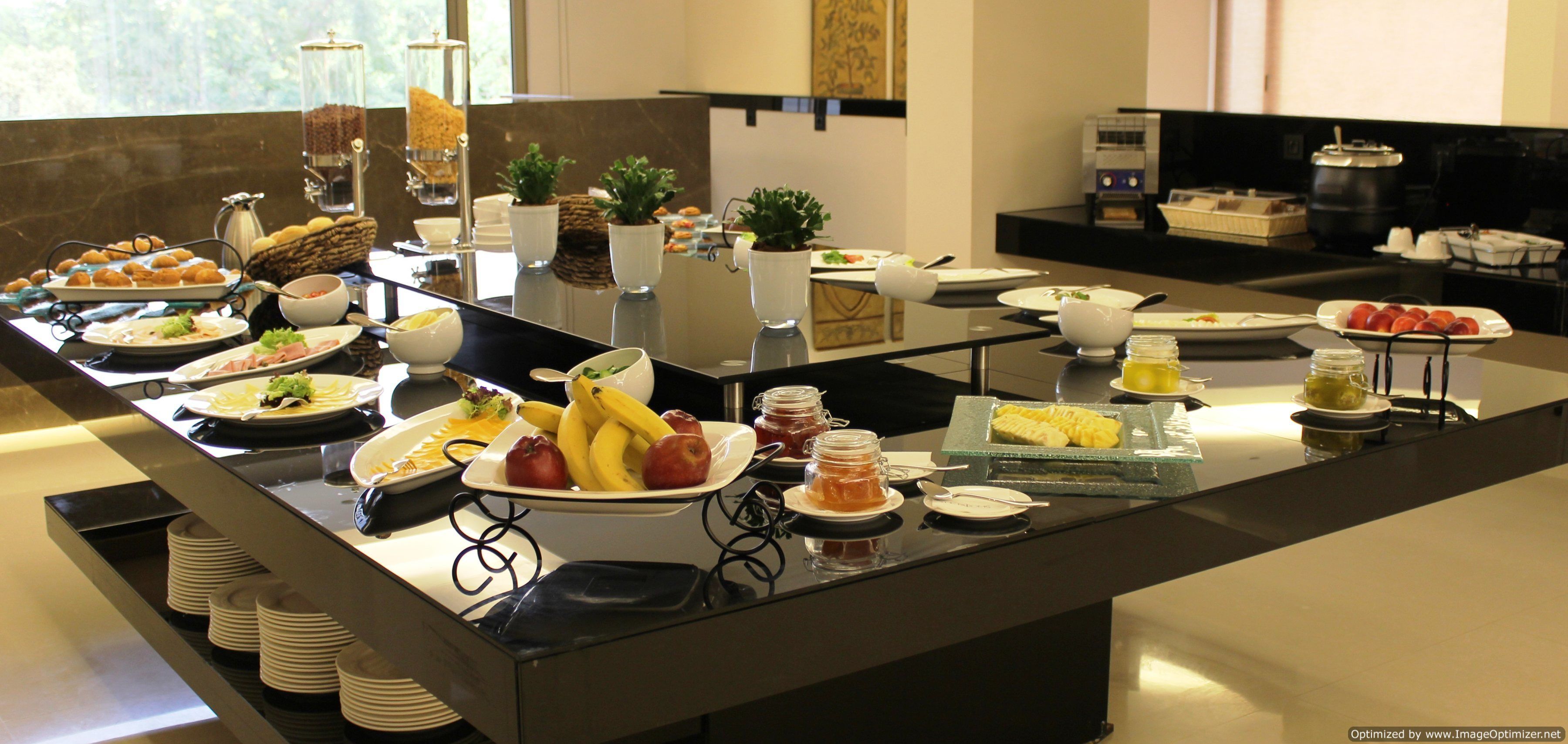 A buffet with various food items and condiments.