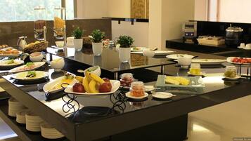 A buffet with various food items and condiments.