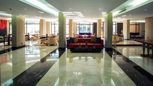 A spacious lobby with a central seating area, large windows, and a polished floor. - The Rooms Boutique Hotel (Jounieh)