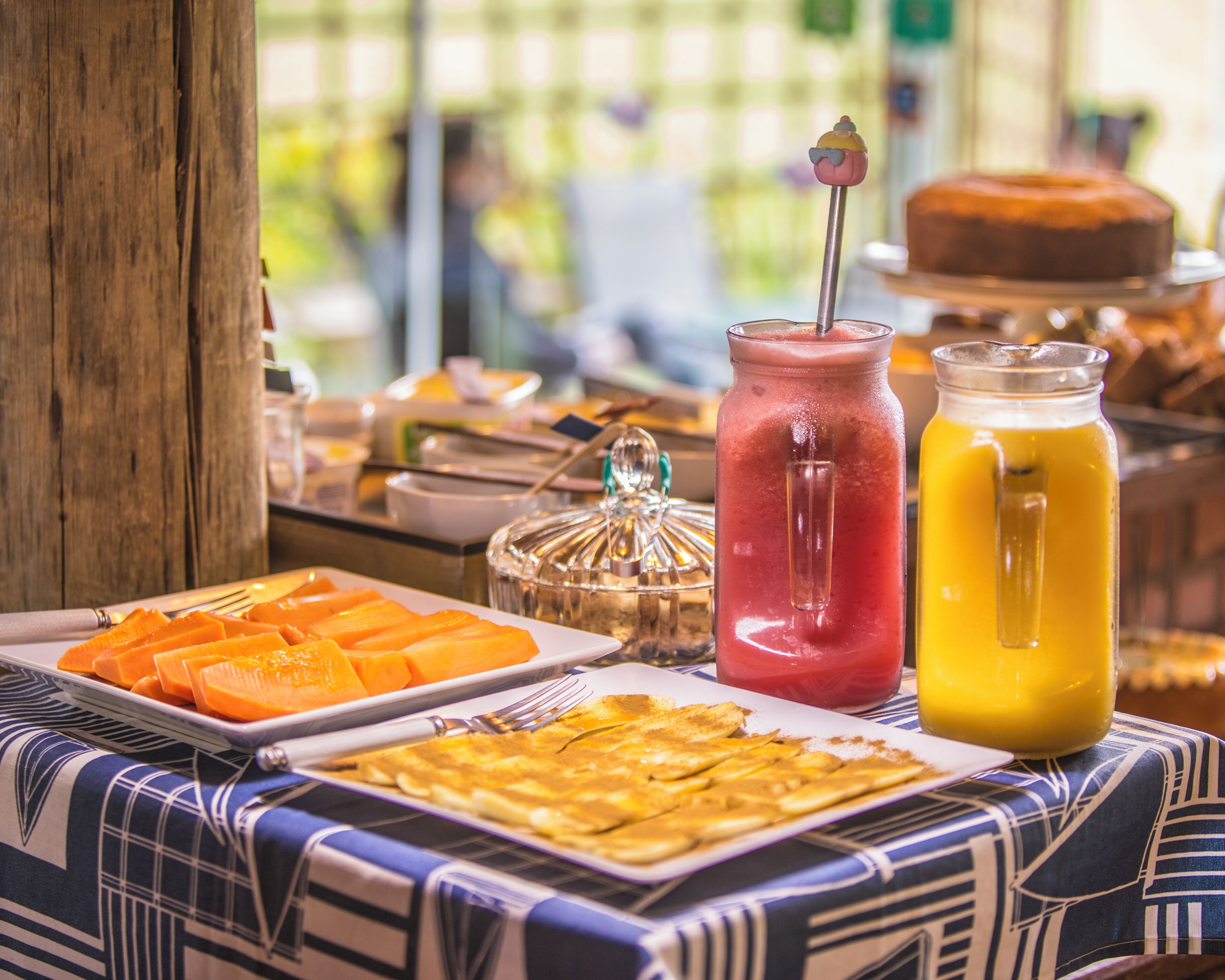 A buffet table with various food items and drinks.