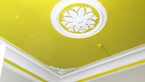 A staircase with a patterned wall and a ceiling with a decorative white circular design. - Back To Lisbon Hostel (Lisbon)