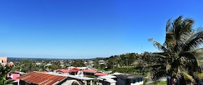A residential area with houses, a road, and a clear blue sky.