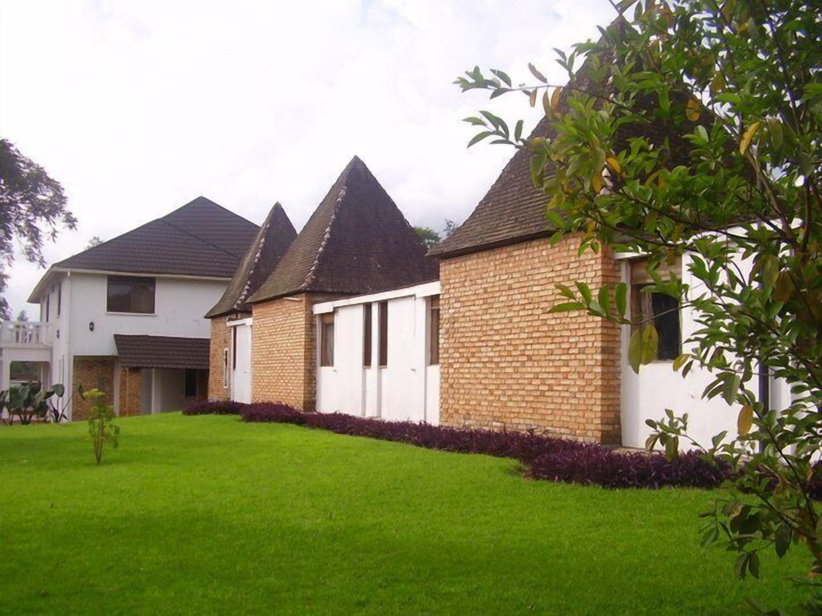 A residential area with a house featuring a brick exterior and a white facade.