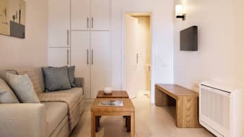 Deluxe Suite | Poolside with Sea view | Living area | 42-inch flat-screen TV with cable channels, TV, printers