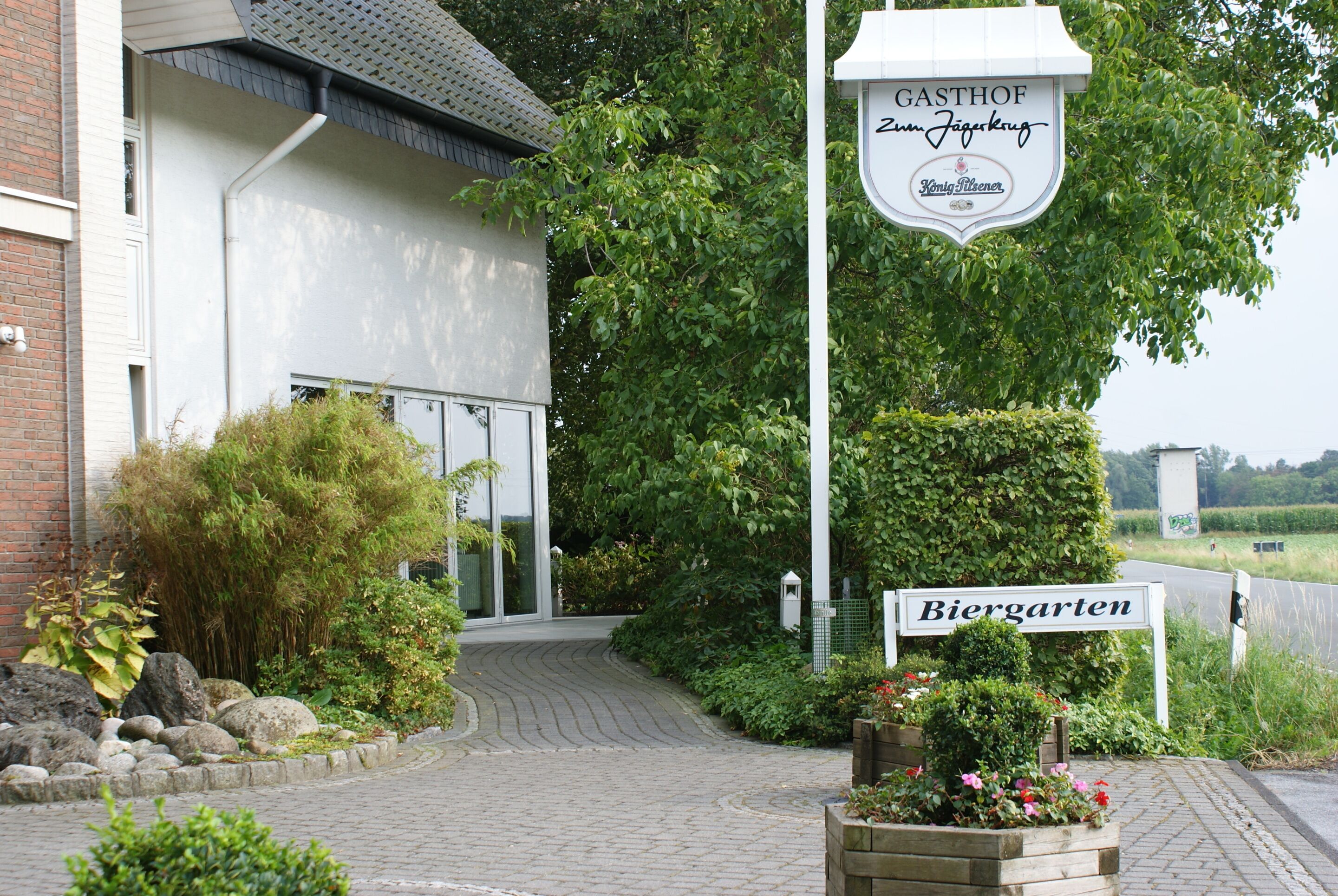 A building with a sign indicating a beer garden and a sign for a location named Biergarten.