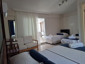 A hotel room with a bed, a sofa, a desk, and a chair. - Hotel Antonio (Cesme)